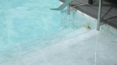 View to swimming pool in clear blue water at stair into the pool for summer.. Stock Footage 276353936