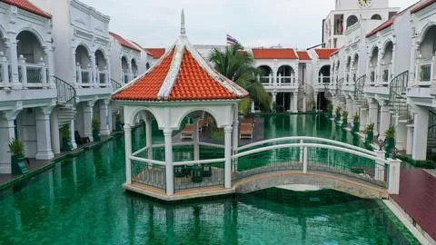View of swimming pool inside the hotel. Green color of swimming pool at the.. Stock Photos