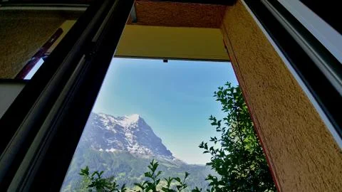 View of Swiss alps mountains through the window in Grindelwald Stock Photos