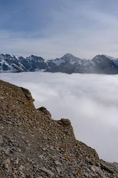 View of Swiss Alps over clouds on a sunny day Stock Photos