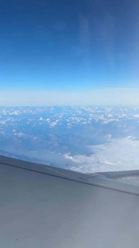 View of the Swiss Alps from the window of a plane 스톡 동영상 303956909