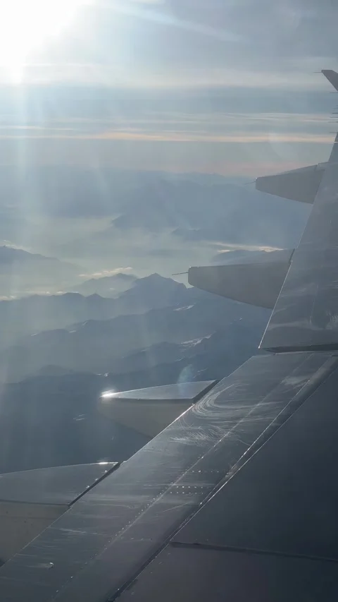 View of the Swiss Alps from the window of a plane Stock Footage 303956944