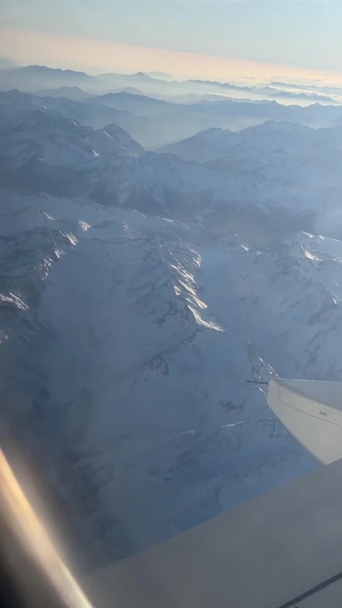 View of the Swiss Alps from the window of a plane Stock Footage 303957057