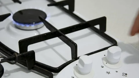 View of the switch of the gas stove, which is turned by the human hand and th Stock Footage 148533554
