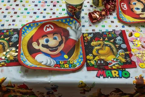 View of table set with Mario-themed decoration, prepared for children's party. Stock Photos