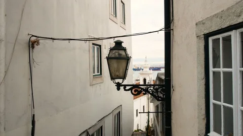 View of the Tagus river with cargo sailing through the walls of houses Video stock 111361452