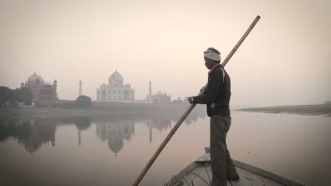 View on Taj Mahal from behind with Indian man on a boat during sunset. Stock Footage 151961153