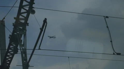 View of the takeoff of the aircraft from the window of a moving train. The view Stock Footage 105873686