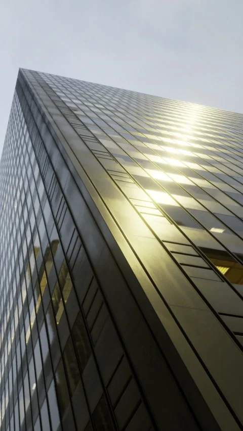 View of a tall building reflecting light in an urban setting during the day Stock Footage 335967130
