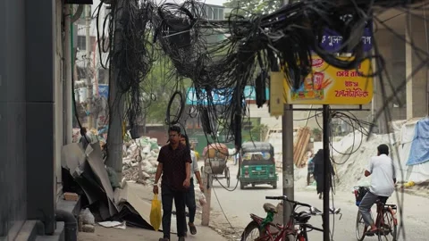 View of tangled overhead cables and street life in Dhaka, Bangladesh. Video stock 335557095