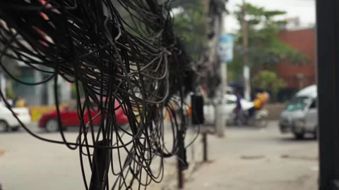 View of tangled overhead power cables on a busy street, Bangladesh. Video stock 335557017