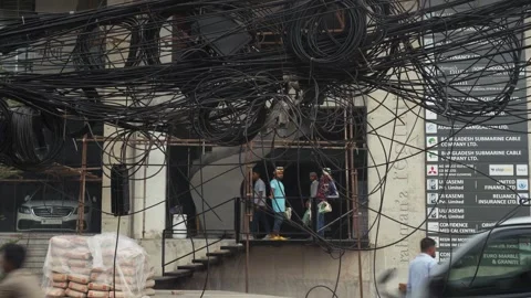 View of tangled overhead wires in front of a building, Bangladesh. Video stock 335557108