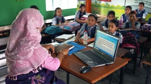 View of a teacher using a laptop in a classroom, Bangladesh. Video stock 335584876