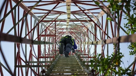 View of a technician climbing a telecommunications tower, Bangladesh. Stock Footage 335561625