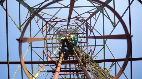 View of a technician climbing a telecommunications tower, Bangladesh. Stock Footage 335561676