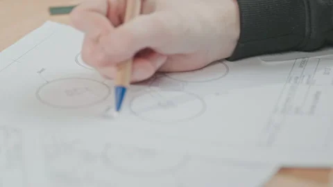 View of technicien projecting quadcopter, drawing drone prototype at workplace Stock Footage 186165722