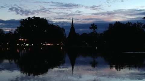 View to the temple reflected in the pond before sunrise in Sukhothai, Thailand. Stock Footage 57853789