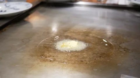 View to teppanyaki pan while fry sliced crispy garlic in hot butter oil for.. Stock Footage 283054422