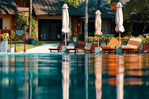 View of thatched cottages over the infinity pool Stock Photos