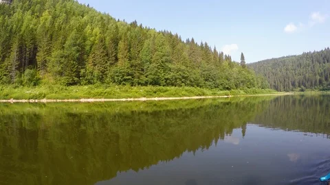 View of thick stand of fir trees on bank of river in Ural mountains. Stock Footage 121338201