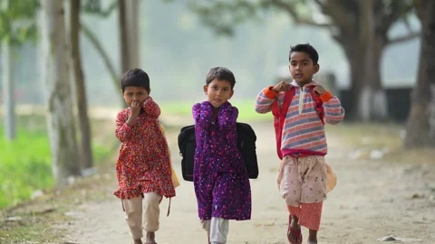View of three children walking along a rural path, Bangladesh. 動画素材 335585752