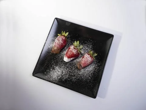 View of three strawberries with chocolate Stock Photos