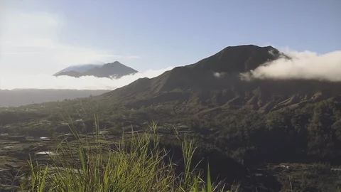 View of three volcanoes in the clouds at dawn. Bali, Indonesia Stock Footage 125553580