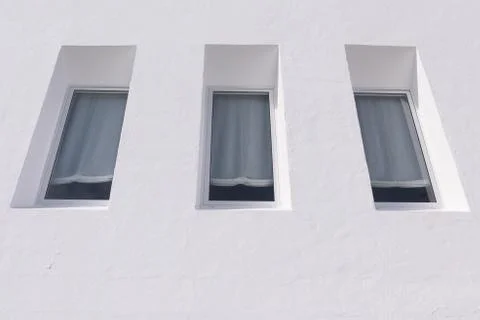 View on three windows of a white house Stock Photos