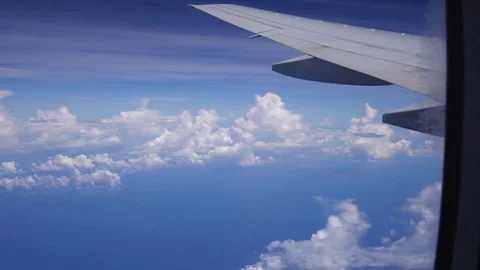 View through aircraft window on blue sky, cloudscape and airplane wing. 4K 스톡 동영상 72110948