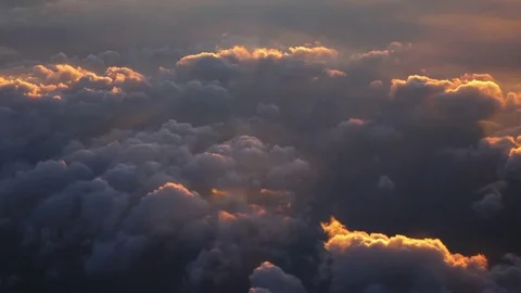 View through aircraft window on cloudscape at sunrise hours. 4k Ultra HD Vídeo Stock 69792877