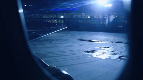 View through the aircraft window at drifting away airport at night. Taking off 스톡 동영상 105273053