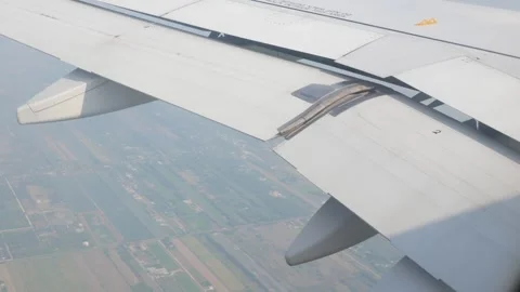 View through aircraft window with plane's wing over from airplane flight fl.. Stock Footage 248198072