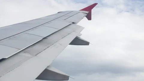 View through aircraft window with plane's wing over green farm field site s.. Stock Footage 274485750