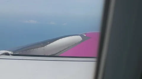 View through aircraft window with plane's wing and engine while take off cl.. Stock-Footage 293927990