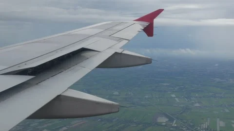 View through aircraft window with plane's wing over green farm field site s.. Stock Footage 301273865