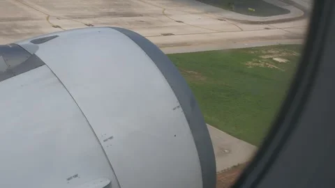 View through airplane aircraft window with jet engine while runny on runway.. Stock Footage 282336293