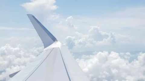 View through airplane aircraft window with wing view while flying in sky ov.. Stock Footage 285298038