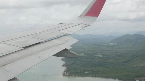 View through airplane aircraft window with wing view while approaching land.. Stock Footage 286316423