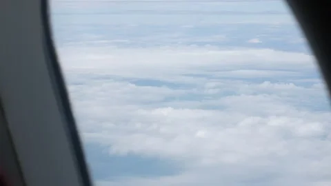 View through airplane window above the clouds and sky inspiration concept i.. 動画素材 313430340