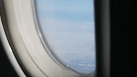View through airplane window above the clouds and sky inspiration concept i.. Video stock 340306075