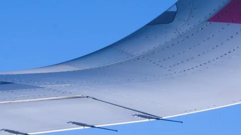View through an Airplane window. Aircraft wing sky clouds Stock Footage 112799817