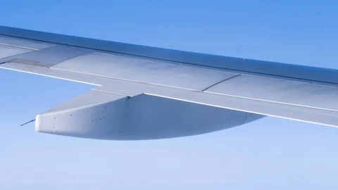 View through an Airplane window. Aircraft wing sky clouds 스톡 동영상 112801083