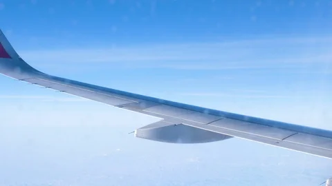 View through an Airplane window. Aircraft wing sky clouds 스톡 동영상 112812122