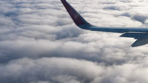 View through an Airplane window. Aircraft banking turn. Wing sky clouds Stock Footage 112813273