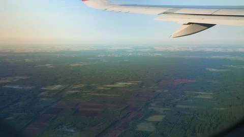 View through an Airplane window. Aircraft wing sky and land 스톡 동영상 112832130