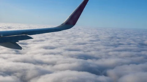 View through an Airplane window. Aircraft banking turn. Wing sky clouds 스톡 동영상 112832525