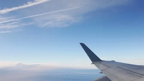 View through an airplane window on another plane. Flying through clouds Video stock 80521739