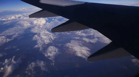 View through an Airplane Window in the Blue Sky in Clouds Video stock 68769928
