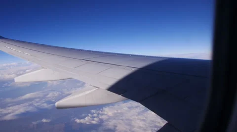 View through an Airplane Window in the Blue Sky in Clouds 스톡 동영상 68770015