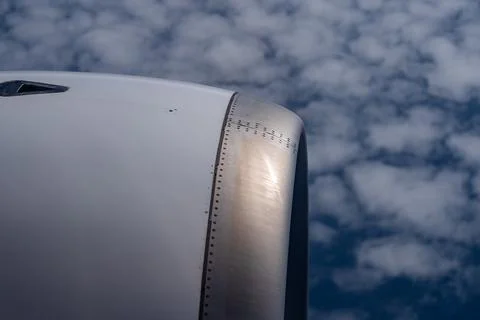 View through airplane window during flight on a Sunny day with cloudy sky Stock Photos